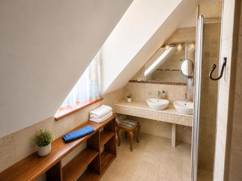 a bathroom with two sinks and a mirror at Férovka in Jeseník