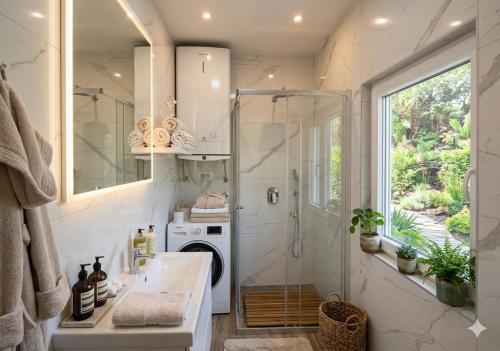 a bathroom with a shower and a washing machine at Отрада in Utjeha