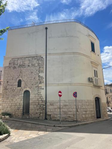a large brick building with a street sign in front of it at Le Dimore di Federico - Trani in Trani