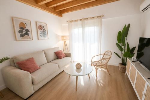 a living room with a couch and a table at Duplex El Acebuche in Arroyo Frio