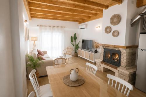a living room with a couch and a fireplace at Duplex El Acebuche in Arroyo Frio