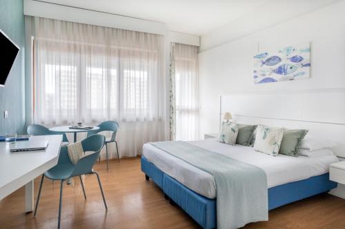 a bedroom with a bed and a table and chairs at Marbela Apartments & Suites in Palermo