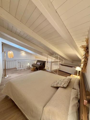 a bedroom with a large bed and a couch at Home Sereia in Trebisacce