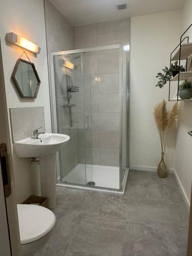 a bathroom with a shower and a sink at House Sleeps 6 with Parking in Coad