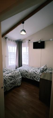 a bedroom with a bed and a television in it at Paralelo46 in Chile Chico
