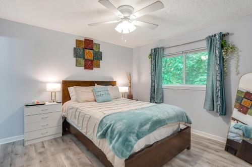 a bedroom with a bed and a ceiling fan at 7 Mi to Downtown Fun! Spacious Augusta Condo in Augusta