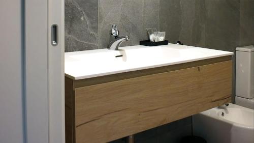 a bathroom with a white sink and a toilet at Ca' Giulia in Rigoso