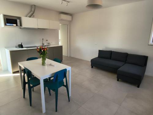 a living room with a table and a couch at Casa Bolina in Senigallia