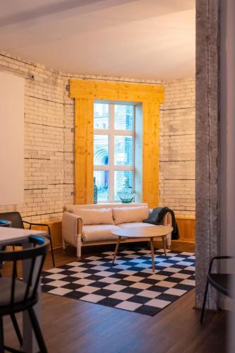 a living room with a couch and a window at Les Villas Saint-Roch in Quebec City