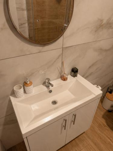 a bathroom with a white sink and a mirror at Old Luxury Stone House Armou in Armu