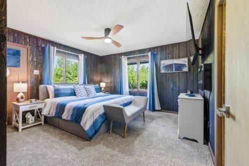 a bedroom with a bed and a ceiling fan at Hiwassee Lake Lodge - Private Mtn-Top Retreat - Lake Views - Sleeps 14 in Murphy