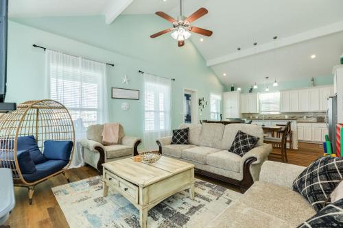 a living room with two couches and a table at Steps from the Jetty & Beach in Surfside Beach