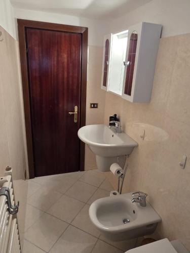 a bathroom with a sink and a toilet and a mirror at VeronaVera Porta Palio Panoramic Loft in Verona