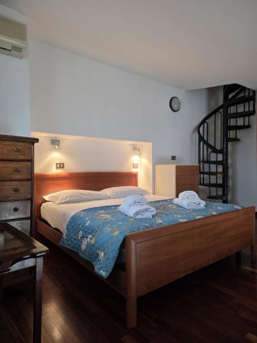a bedroom with a bed with two towels on it at VeronaVera Porta Palio Panoramic Loft in Verona