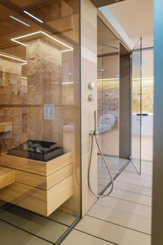 a shower with a glass door in a bathroom at Metamare in Cozze