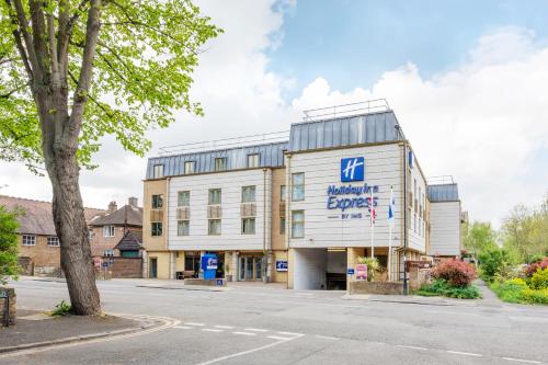 a building with a sign on the front of it at Holiday Inn Express Windsor by IHG in Windsor