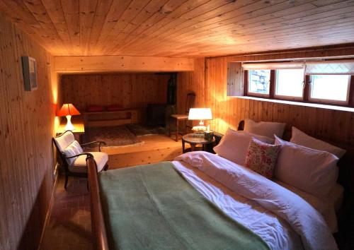 a bedroom with a bed in a wooden room at Sanctuary Apartment nestled in nature in Westport