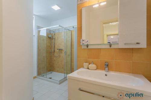 a bathroom with a sink and a shower at Villa Stone and Sea Escape by Apulia Accommodation in Cozze
