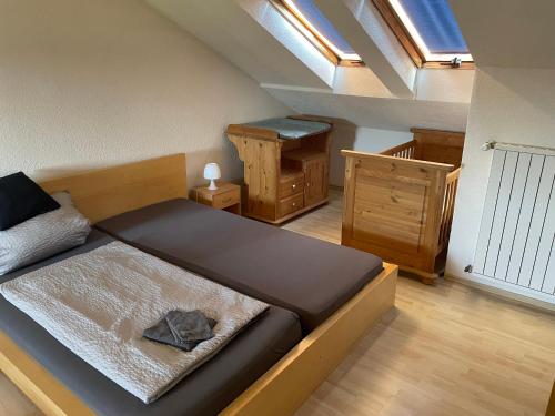 a small bedroom with a bed and a staircase at Ferienwohnung in Weilburg in Weilburg