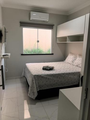 a bedroom with a bed and a window at Casa Melcon in Aquiraz