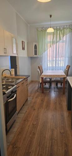 a kitchen with a table and a dining room at Apartament M J w Centrum-Dwa Pokoje in Ząbkowice Śląskie