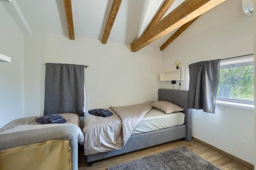a small bedroom with a bed and a window at Villa Pepa by Istra Vacation in Pazin