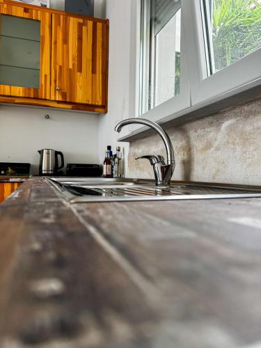 a kitchen counter top with a sink and a window at Infinite Blue Maisonette with Panoramic Terrace in Ámpelos