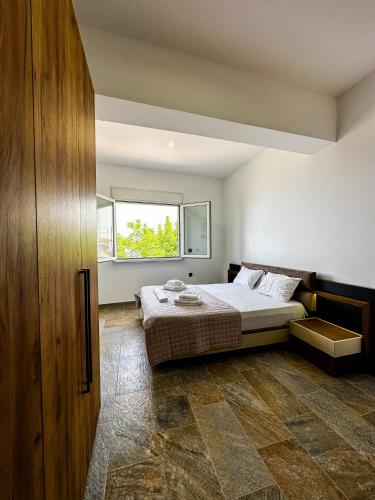 a bedroom with a bed and a window at Infinite Blue Maisonette with Panoramic Terrace in Ámpelos