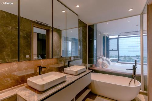 a bathroom with two sinks and a large mirror at ChiHome Metropole The Opera Residence Luxury in Ho Chi Minh City