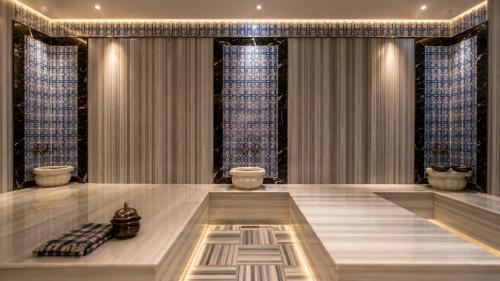 a large room with a table and blue curtains at Mai İnci Otel in Antalya