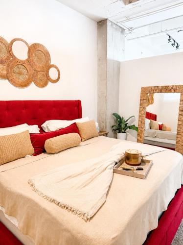 a bedroom with a large bed with a red headboard at Ember Sky Penthouse in Atlanta