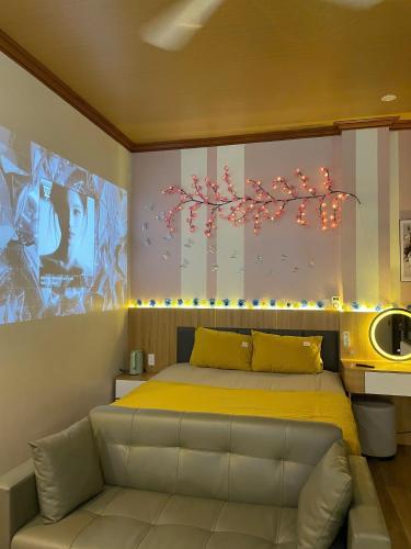 a bedroom with a bed with a yellow bedspread at ChillDate in Bắc Ninh