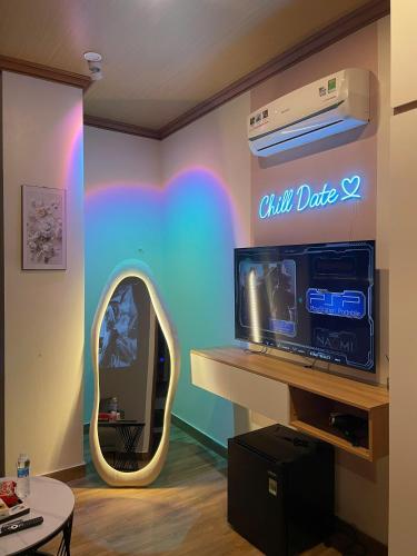 a room with a wall with a tv and a mirror at ChillDate in Bắc Ninh