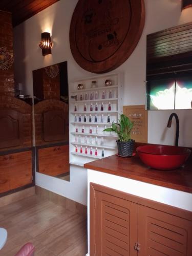 a bathroom with a counter with a red bowl on it at RESONAMUH - Hostel in São Pedro da Aldeia