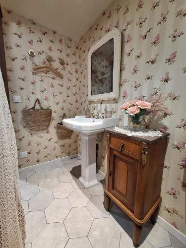 a bathroom with a sink and a mirror at Chez Mémère in Rolleville