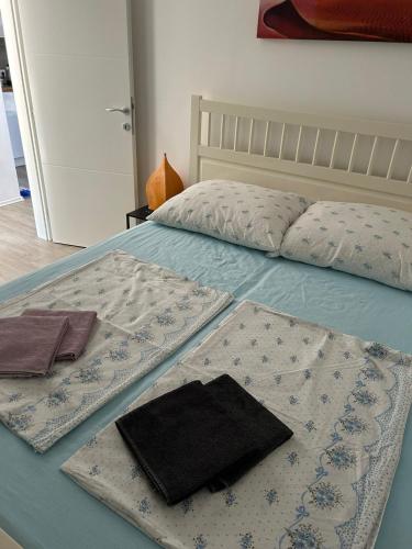 a bed with a blue comforter and pillows on it at Apartment Barba in Bribir