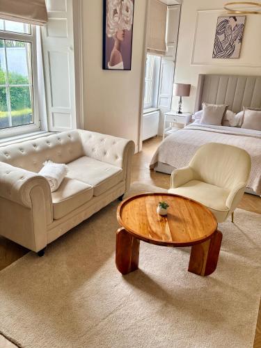 a living room with a couch and a coffee table at Flora in ApartNest Auchterarder in Auchterarder