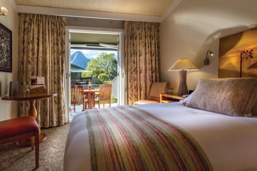 a hotel room with a bed and a table and chairs at Sanctuary Lodge, A Belmond Hotel, Machu Picchu in Machu Picchu
