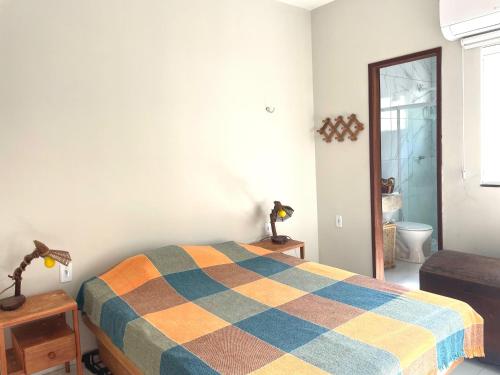 a bedroom with a bed with a colorful blanket on it at Casa Expocrato in Crato