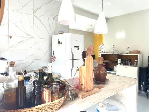 a kitchen counter with bottles and utensils on it at Casa Expocrato in Crato