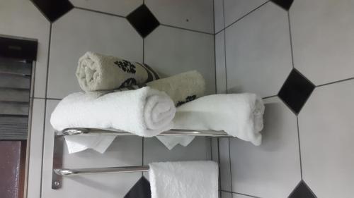 a towel rack with towels on it in a bathroom at Jabula Kruger Safari Lodge in Marloth Park