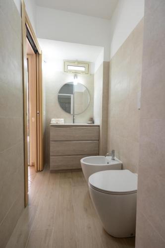 a bathroom with a white toilet and a sink at Ciccio's House in Giardini Naxos