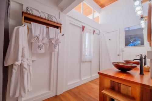 a bathroom with a sink and a bowl on a counter at Aruna Resort & Villas in San Pedro