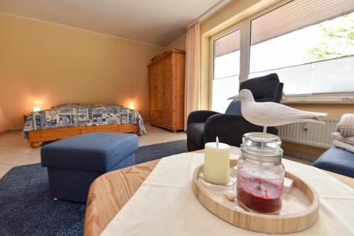 a living room with a room with a bed and a table at Haus "Luv und Lee" Appartement LUV34 in Döse