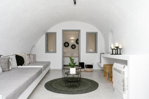 a living room with a couch and a table at Anemos Fira Caldera View in Fira