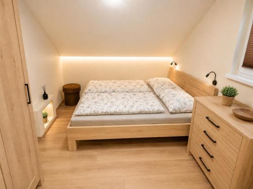 a small bedroom with a bed and a dresser at Chata Adrian Slovak Paradise in Spišské Tomášovce