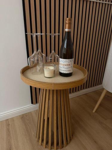 a bottle of wine sitting on a table with glasses at Enjoy-Zimmer in Altenahr