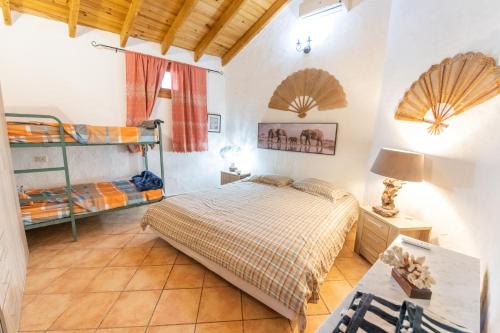a bedroom with a bed and two bunk beds at Finca OASIS Fataga in Maspalomas