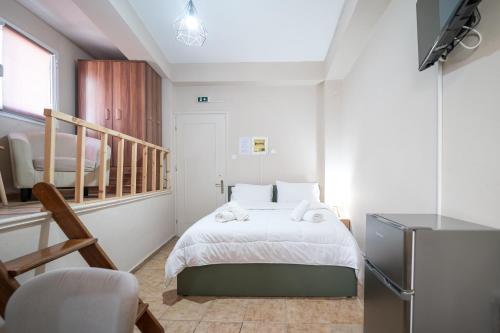 a small bedroom with a bed and a staircase at Nisaki City Vibes in Chios