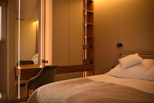 a bedroom with a bed and a desk and a mirror at Słoneczna Polana in Żabiczyn